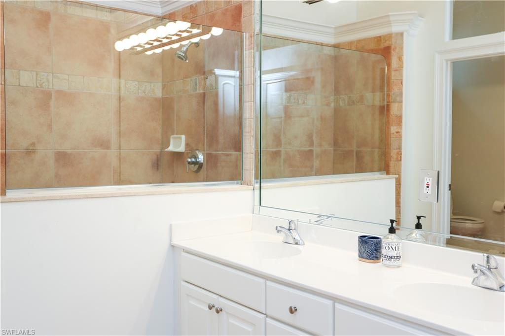 1136 6th Street South, Unit 5 Naples, FL 34102 - Photo 17 of 50 a bathroom with a sink and a mirror