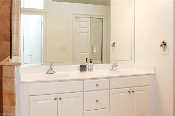 a bathroom with 2 sink and a mirror