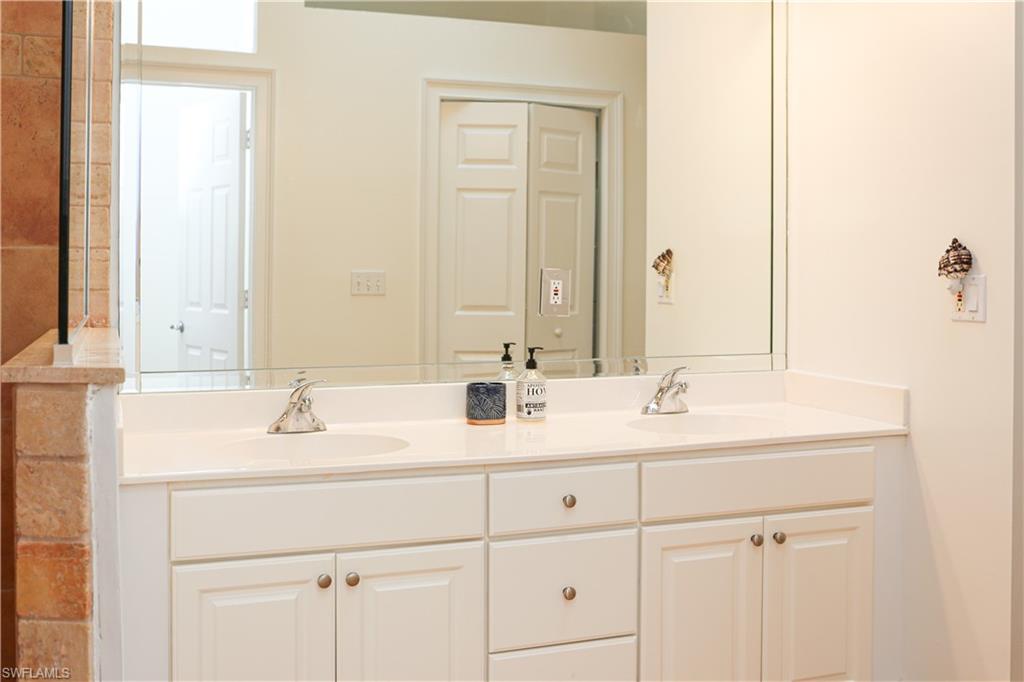 1136 6th Street South, Unit 5 Naples, FL 34102 - Photo 18 of 50 a bathroom with 2 sink and a mirror