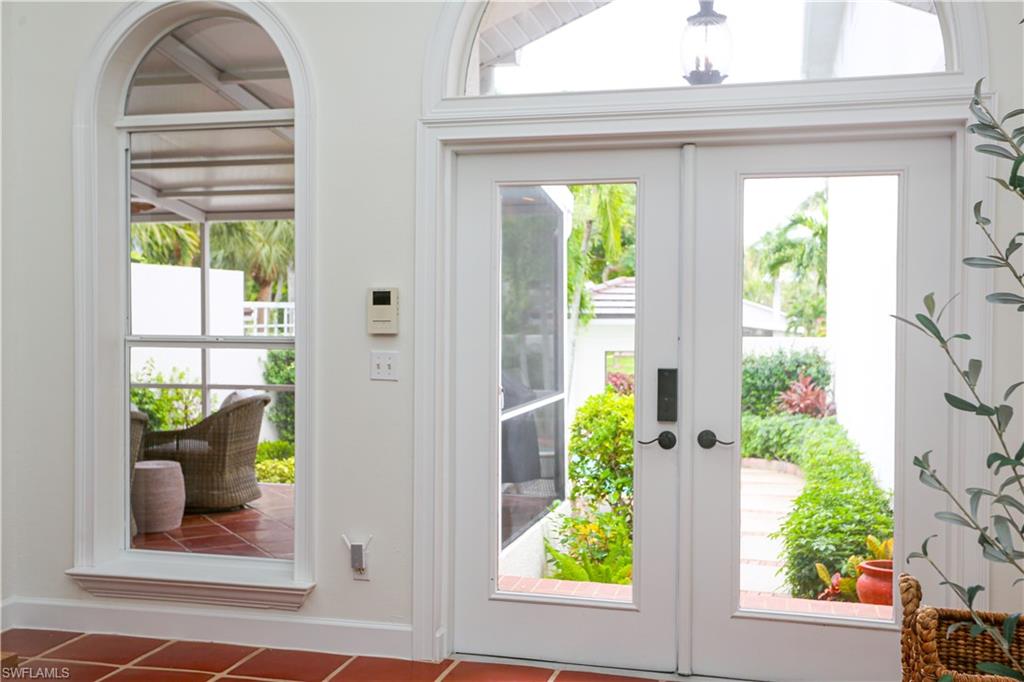 1136 6th Street South, Unit 5 Naples, FL 34102 - Photo 2 of 50 a front view of a house with garden
