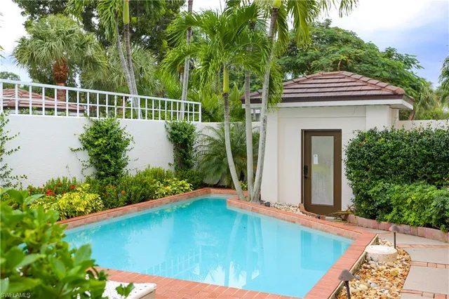 swimming pool view with a garden space