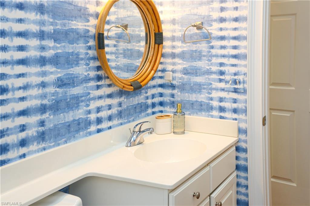 1136 6th Street South, Unit 5 Naples, FL 34102 - Photo 23 of 50 a bathroom with a sink and a mirror