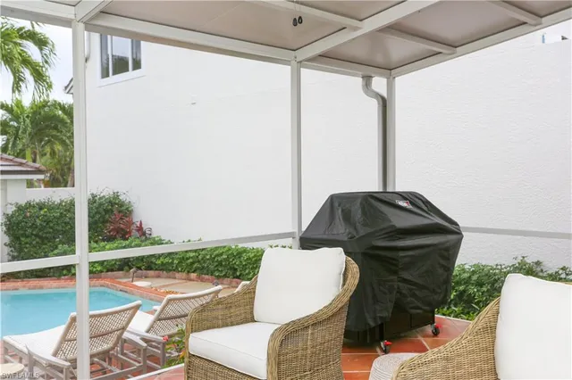 a view of a porch with furniture and a yard