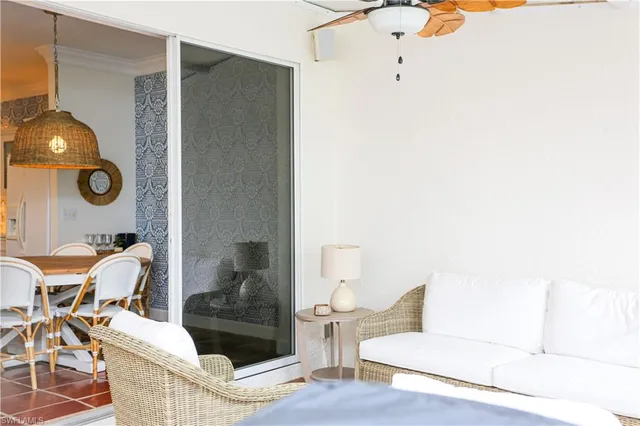 a living room with couches and a potted plant