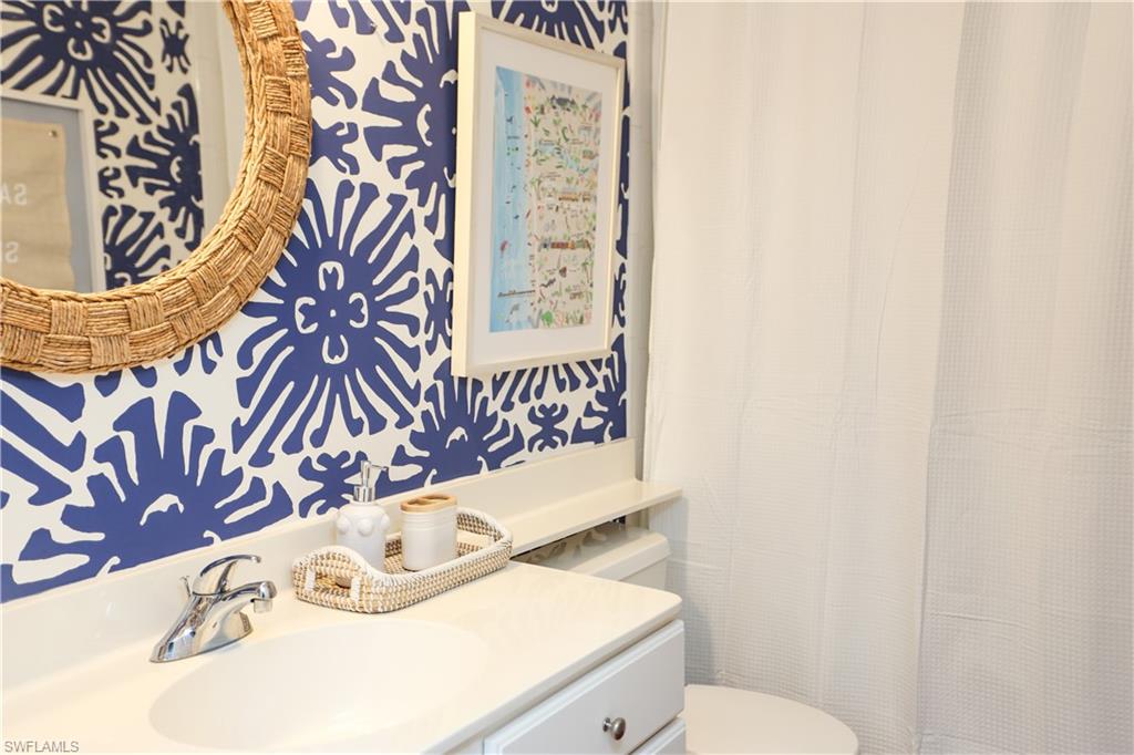 1136 6th Street South, Unit 5 Naples, FL 34102 - Photo 32 of 50 a bathroom with a sink a toilet and a mirror