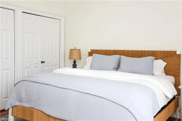 a bedroom with a bed and a lamp