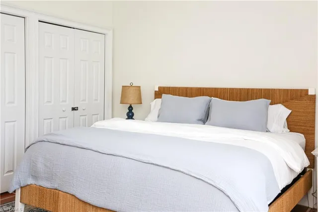 a bedroom with a bed and a lamp