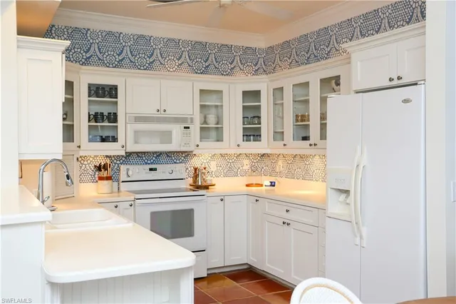 a kitchen with a sink stove and refrigerator