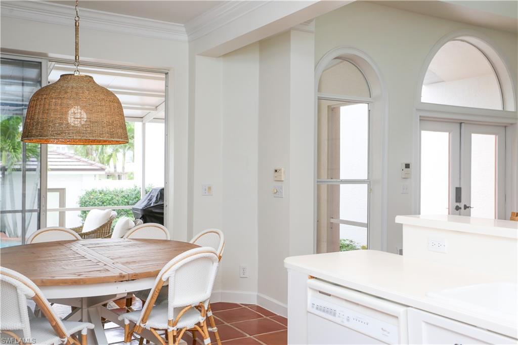 1136 6th Street South, Unit 5 Naples, FL 34102 - Photo 44 of 50 a room with a table chairs and a chandelier