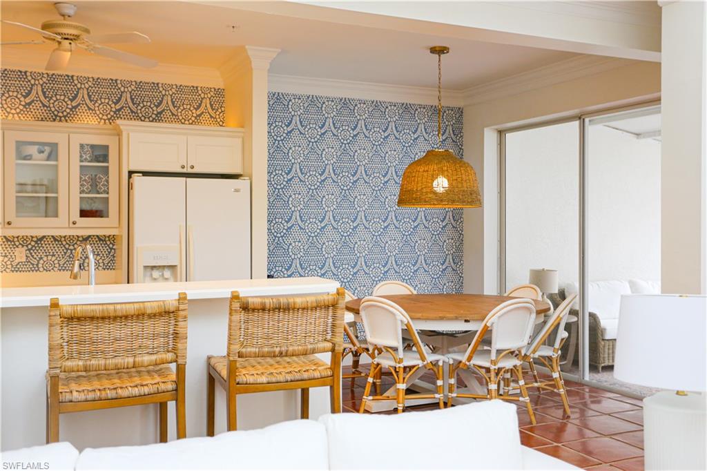 1136 6th Street South, Unit 5 Naples, FL 34102 - Photo 46 of 50 a view of a dining room with furniture and chandelier
