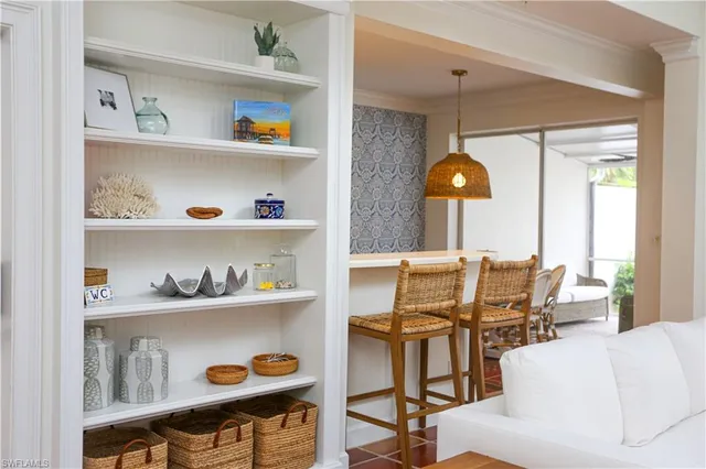 a view of a dining room with furniture and chandelier