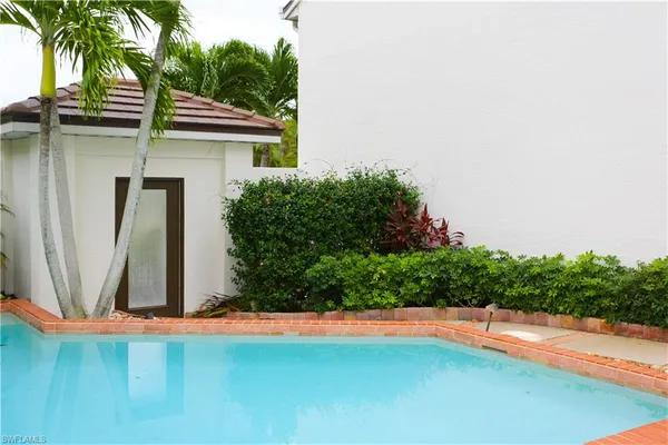 an outdoor space with pool and furniture