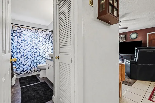 a bedroom with a bed and a bookshelf