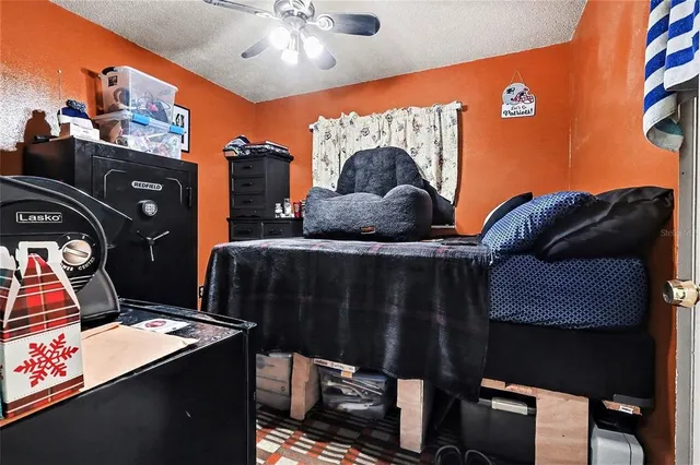 a bedroom with a bed a mirror and a window