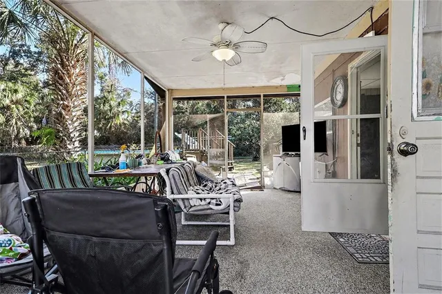 a view of a chairs and table on the backyard