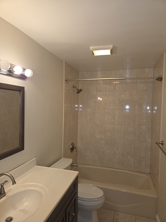 25 Arlington Road, Unit 11 Woburn, MA 01801 - Photo 11 of 14 a bathroom with a sink a toilet and shower