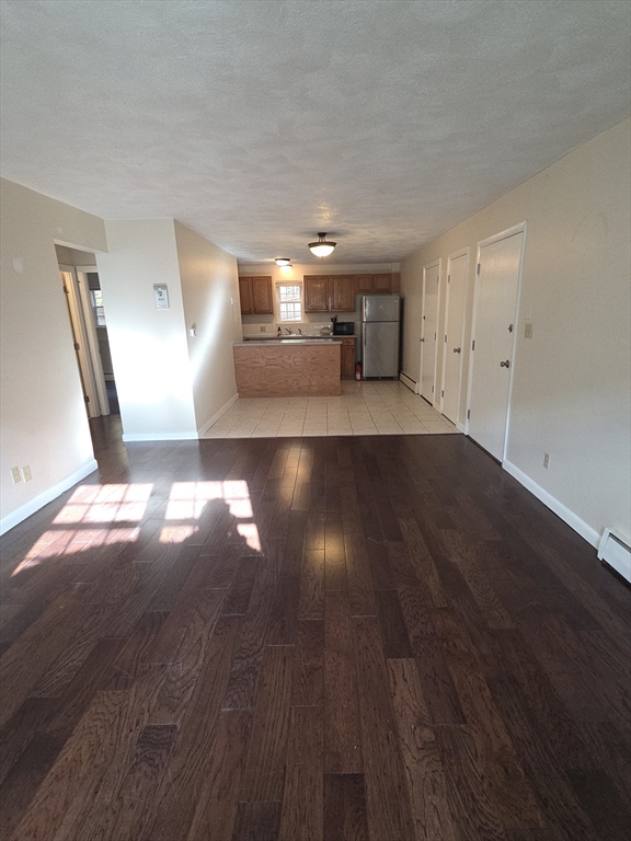 25 Arlington Road, Unit 11 Woburn, MA 01801 - Photo 3 of 14 a view of empty room with wooden floor