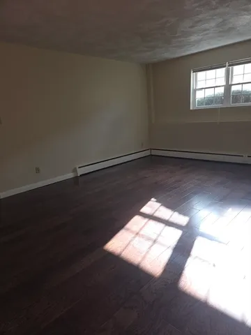 a view of wooden floor and windows in an empty room