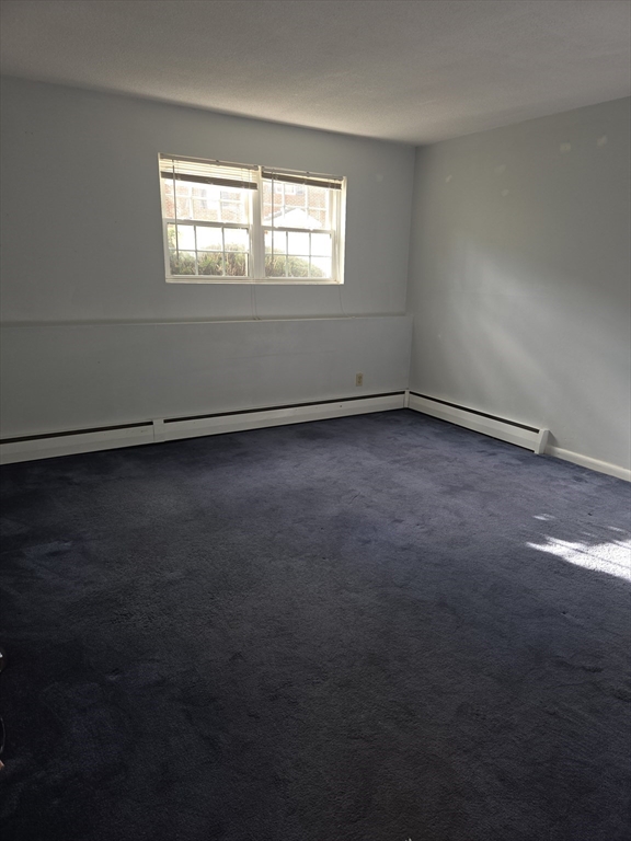 25 Arlington Road, Unit 11 Woburn, MA 01801 - Photo 9 of 14 an empty room with a window