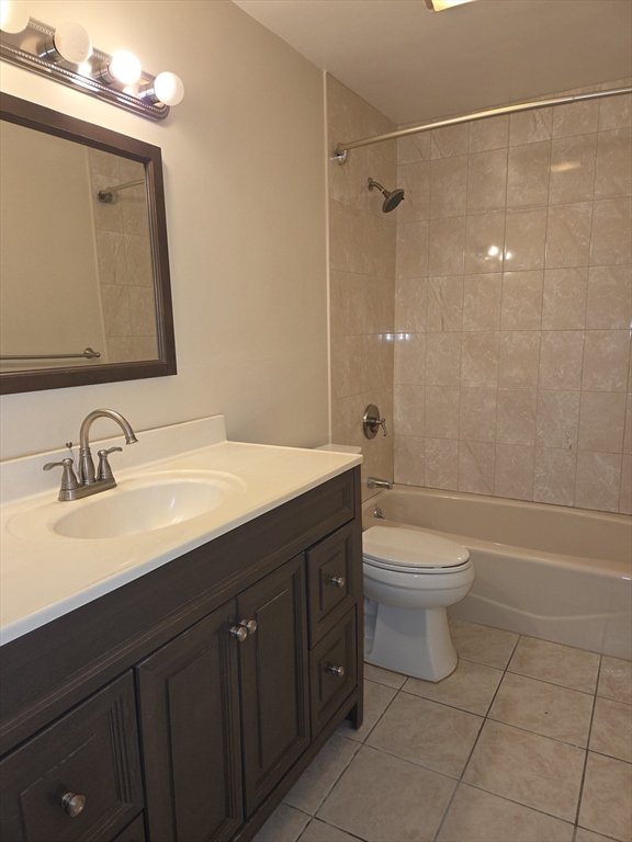 25 Arlington Road, Unit 11 Woburn, MA 01801 - Photo 10 of 14 a bathroom with a sink a toilet and shower