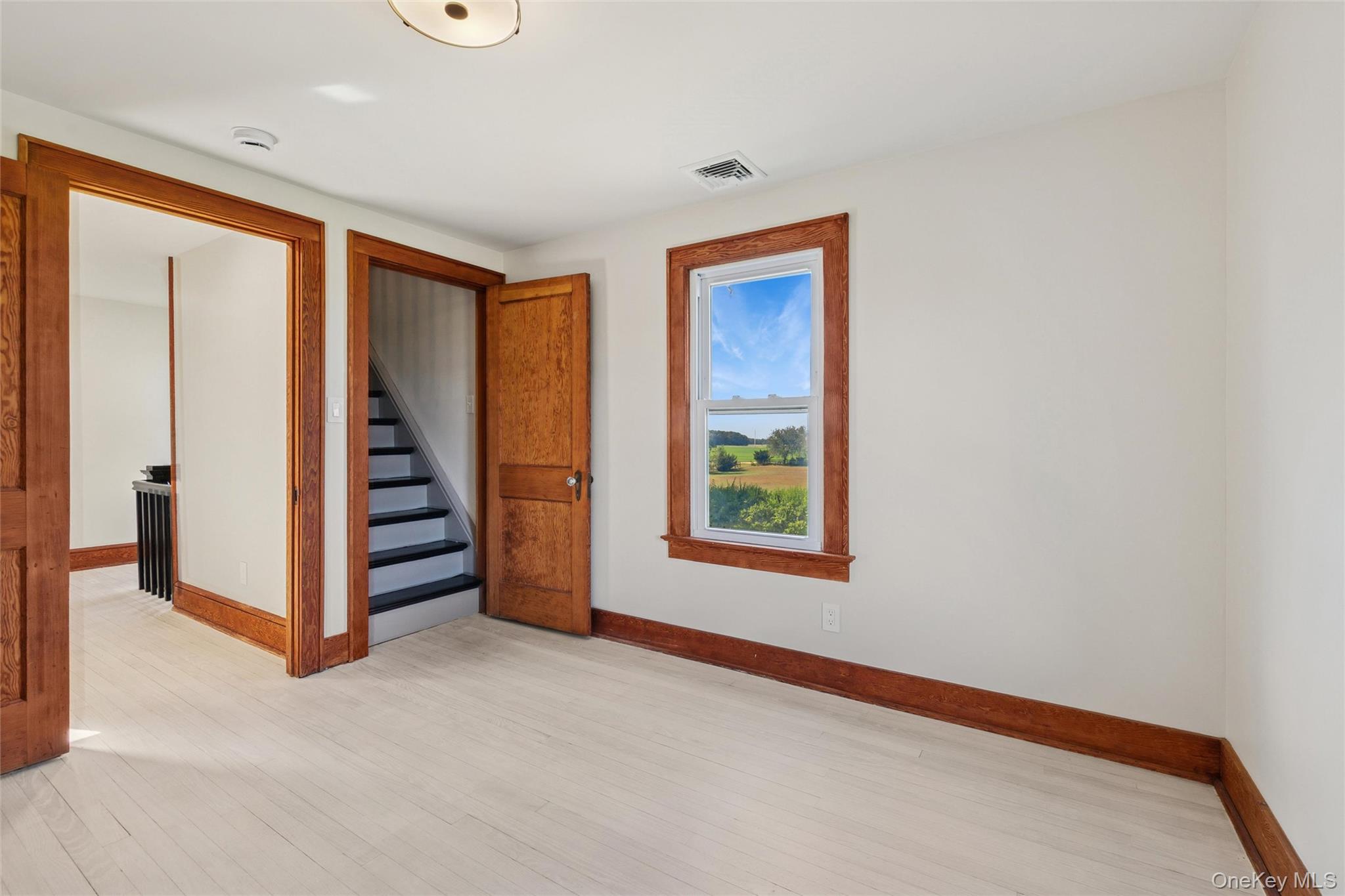 335 Herricks Lane, Unit A Jamesport, NY 11901 - Photo 11 of 18 an empty room with windows and closet