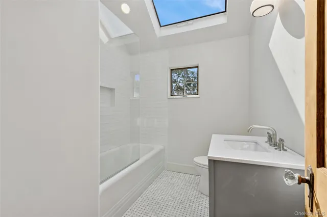 a bathroom with a sink a mirror and a bathtub
