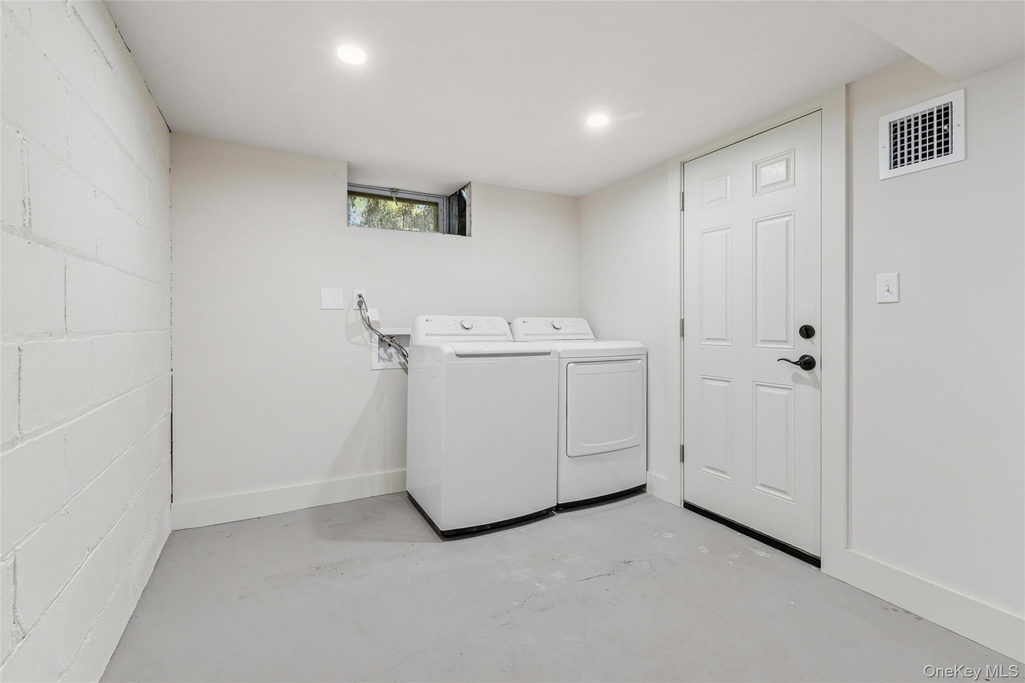 335 Herricks Lane, Unit A Jamesport, NY 11901 - Photo 16 of 18 a utility room with dryer and washer