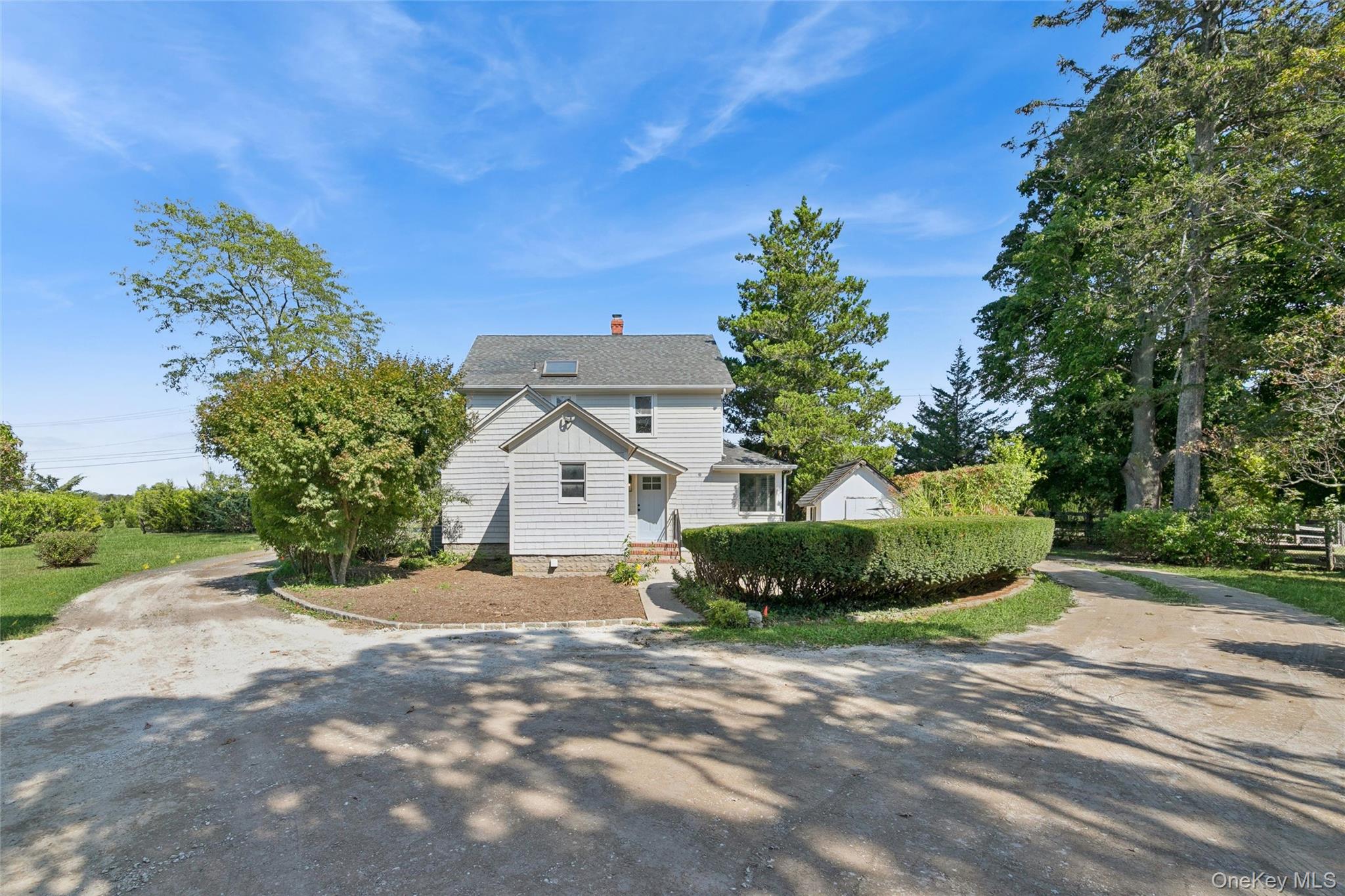 335 Herricks Lane, Unit A Jamesport, NY 11901 - Photo 17 of 18 a front view of a house with a yard