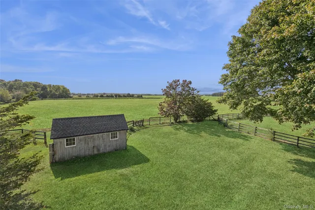 a backyard of a house with a yard and outdoor seating