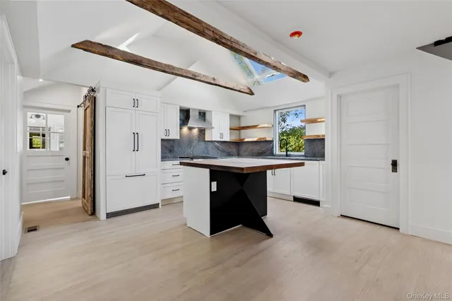 a kitchen with stainless steel appliances kitchen island granite countertop a sink and cabinets