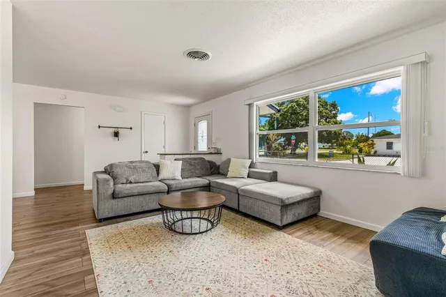 a living room with furniture and a large window