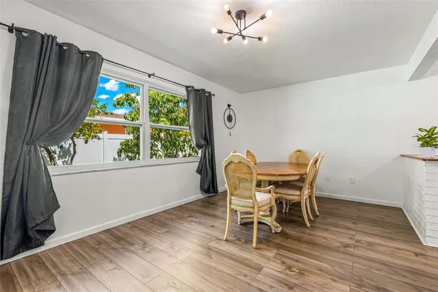 a dining room with furniture a window and a chandelier