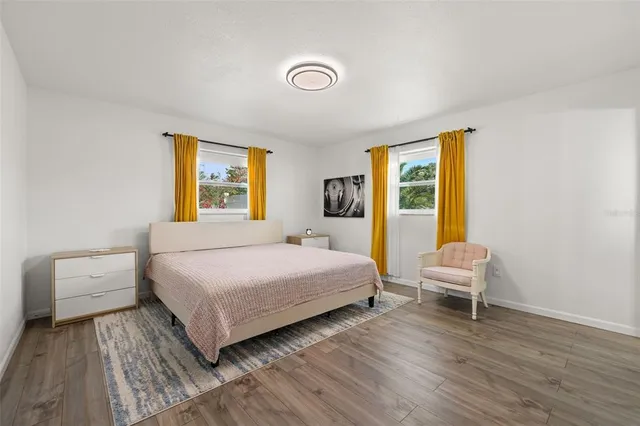 a bedroom with a bed and a chair