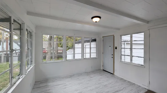 wooden floor in an empty room with a window