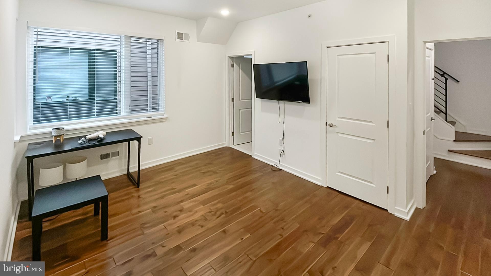 4727 Walnut Street, Unit 4 Philadelphia, PA 19139 - Photo 16 of 26 a livingroom with wooden floor and a flat screen tv