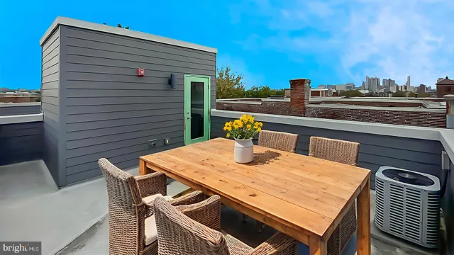 a view of an outside dining space with furniture