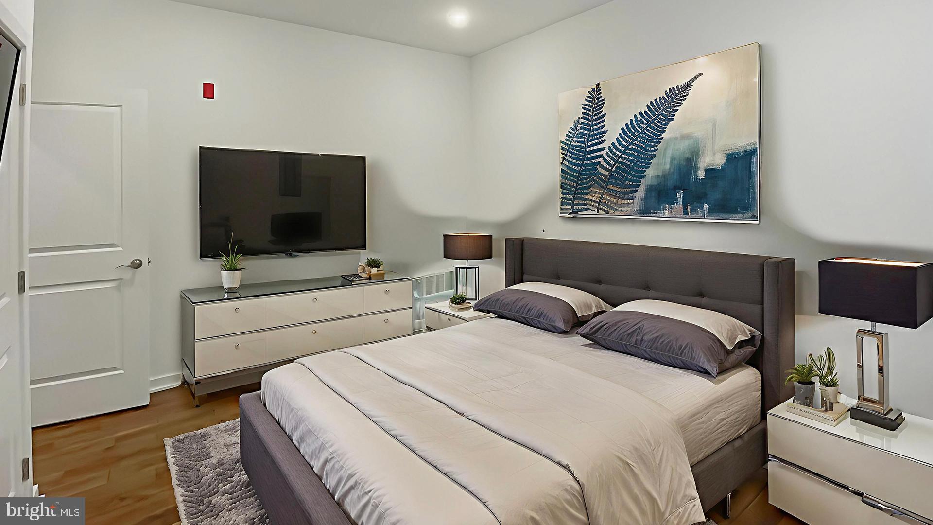 4727 Walnut Street, Unit 4 Philadelphia, PA 19139 - Photo 9 of 26 a bedroom with a bed and a flat screen tv