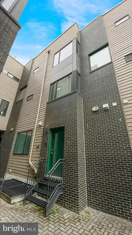 a kitchen with a sink a refrigerator and cabinets