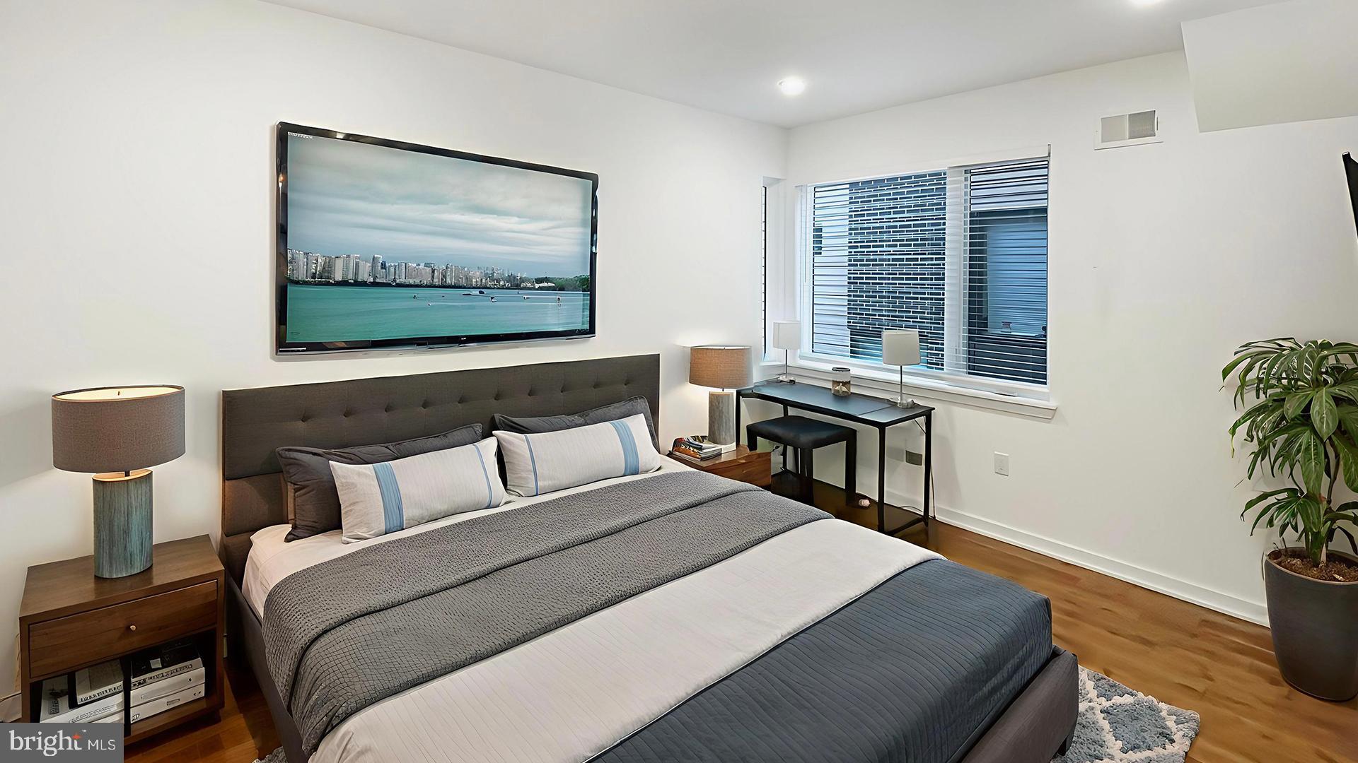 4727 Walnut Street, Unit 4 Philadelphia, PA 19139 - Photo 10 of 26 a bedroom with furniture and a flat screen tv