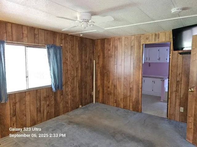 a bathroom with a granite countertop toilet sink and mirror