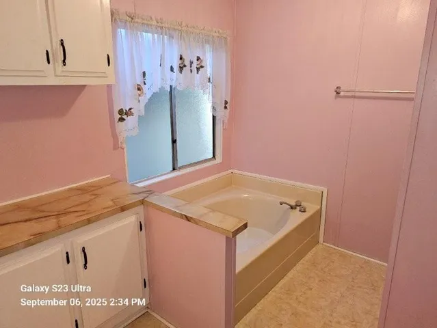 a view of room with window and furniture