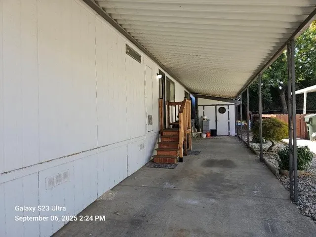 a view of an empty room with a fireplace and a window