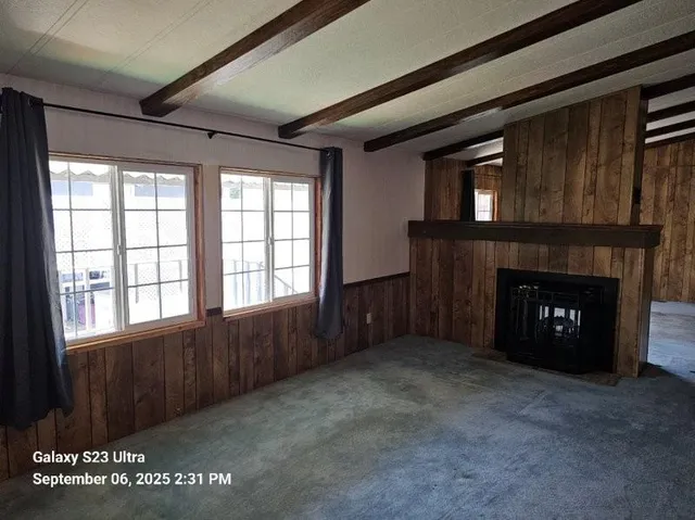 a kitchen with stainless steel appliances wooden floor and a counter top space