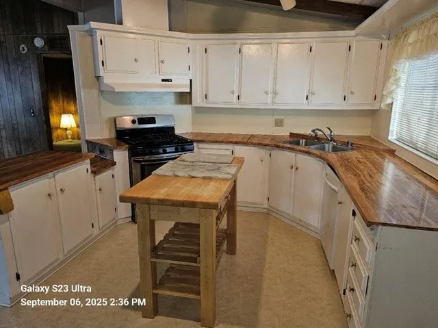 a kitchen with a appliances and cabinets