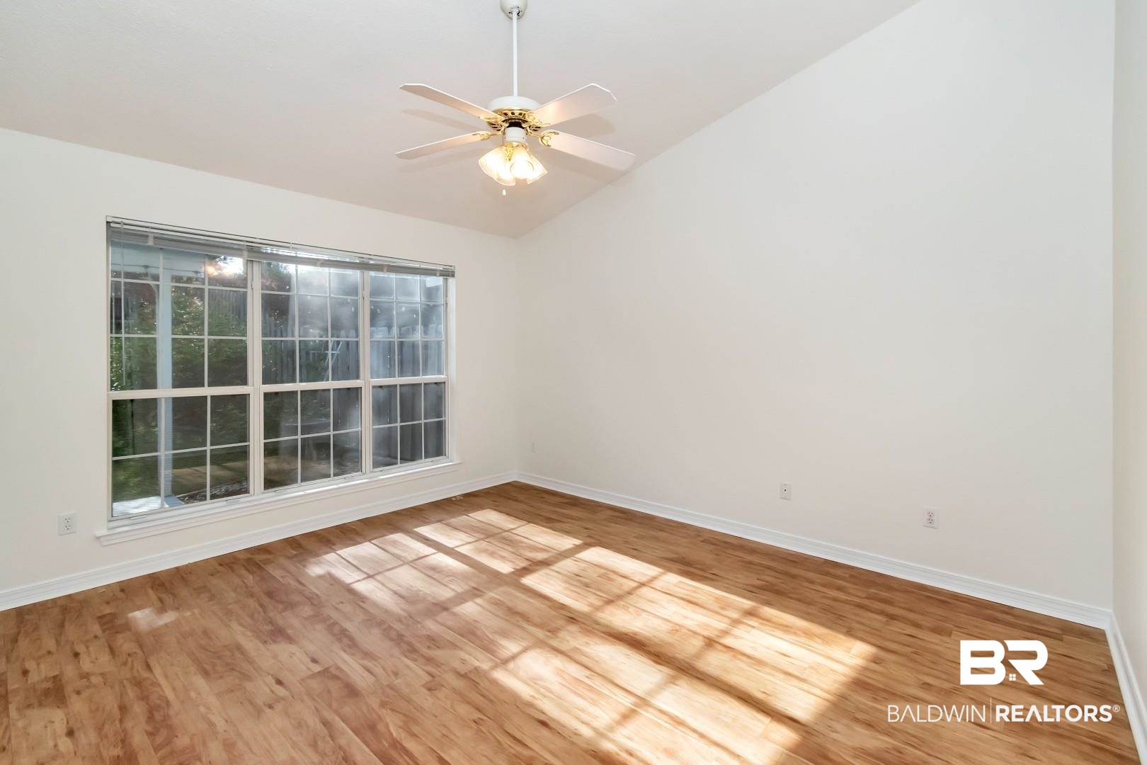 672 Spring Lake Drive East Mobile, AL 36695 - Photo 17 of 26 Spare room with baseboards, light wood-style floors, ceiling fan, and vaulted ceiling