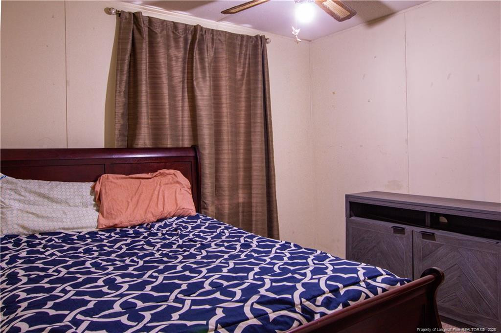231 Knight Lane Autryville, NC 28318 - Photo 24 of 27 a bedroom with a bed and a lamp with the dresser