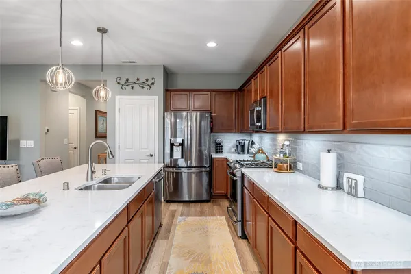 a kitchen with a sink stove and cabinets
