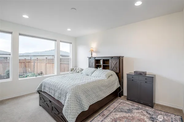 a bedroom with a large bed and a large window