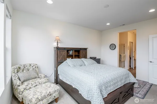 a bedroom with a large bed and a couch