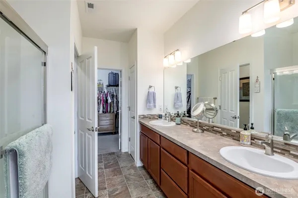 a spacious bathroom with a double vanity sink and a mirror